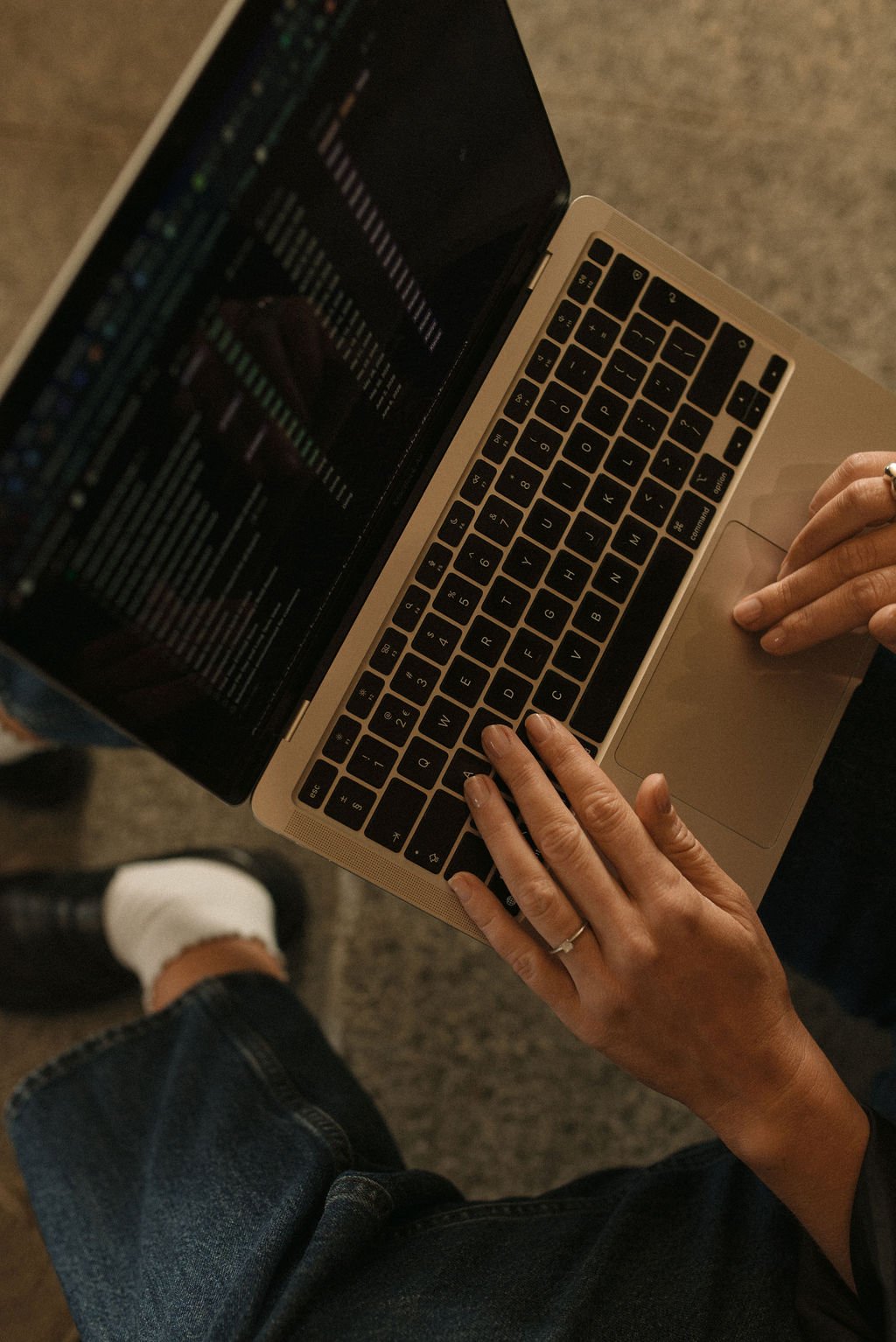 Hands working on a laptop