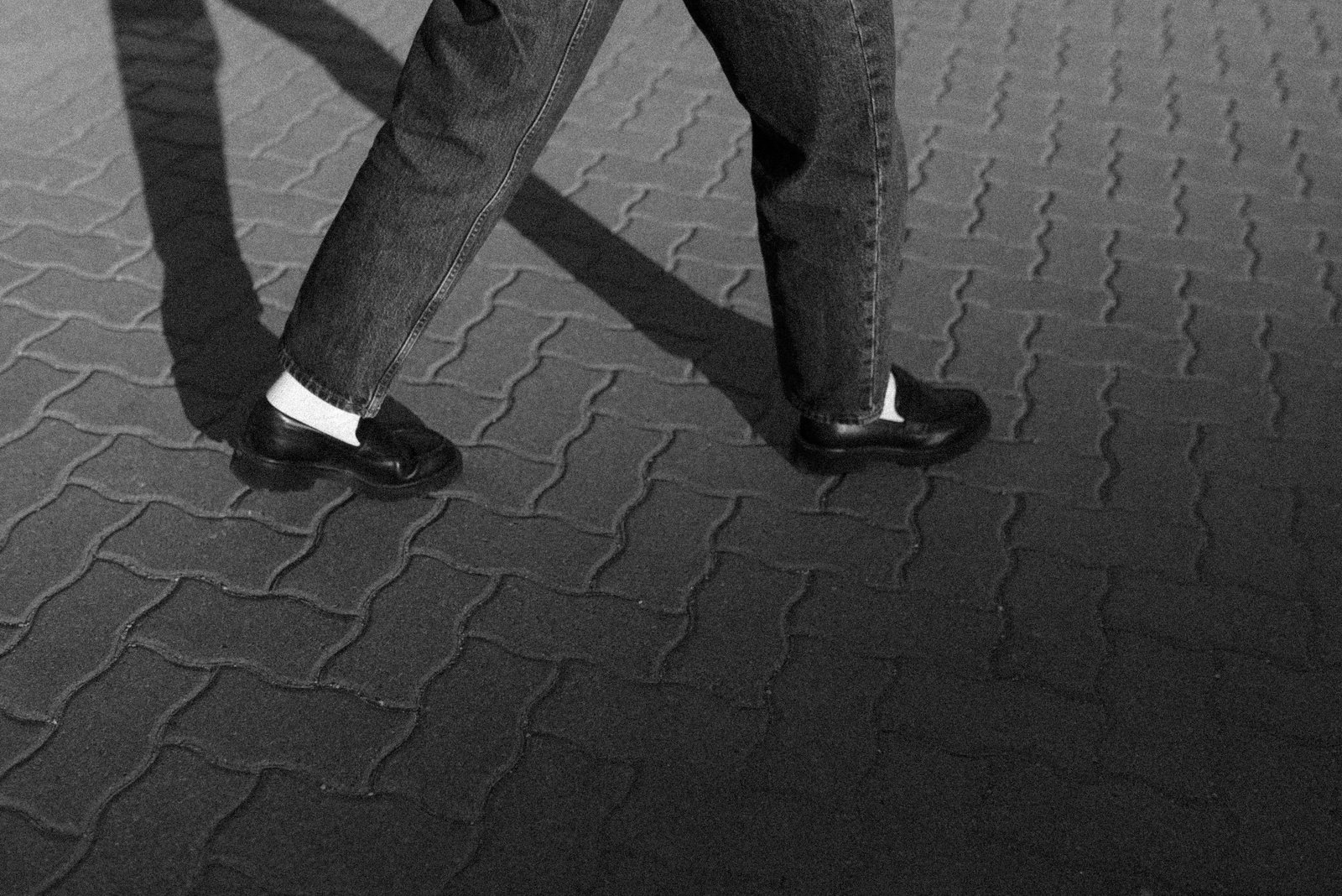 Black and white detail photograph of walking feet